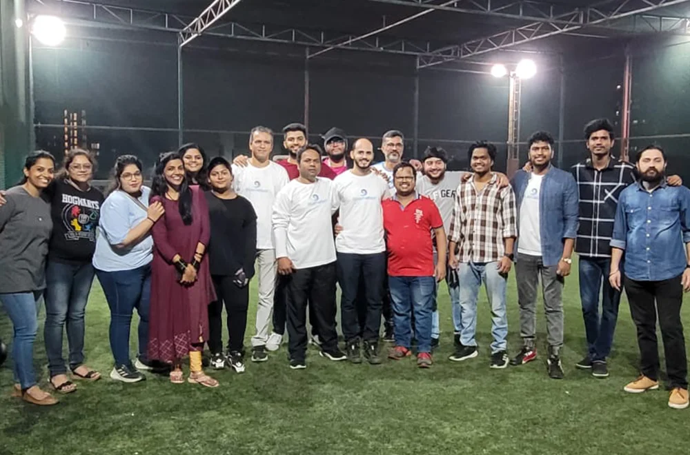 A group of Bluemeteor team members together on a sports field